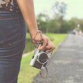 woman hand holding retro camera. young hipster girl photographer with film camera Royalty Free Stock Photo