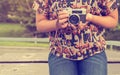Woman hand holding retro camera. young hipster girl photographer with film camera Royalty Free Stock Photo