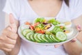 Woman hand holding salad dish eating healthy food closeup Royalty Free Stock Photo