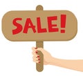 Woman hand holding a sale sign post