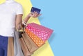 Woman hand holding shopping bag and showing credit card isolated over colorful background. banner with copy space Royalty Free Stock Photo