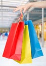 Woman hand holding shopping bags in shopping mall Royalty Free Stock Photo