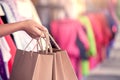 Woman hand holding shopping bags on the street Royalty Free Stock Photo