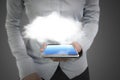 Woman hand holding smart phone with illuminated cloud Royalty Free Stock Photo