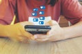 Woman hand holding smartphone with hologram or icon of set communication technology and social media