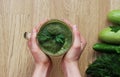 Woman hand holding smoothie shake against pink wall. Drinking green healthy smoothie concept Royalty Free Stock Photo