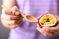 Woman hand holding spoon for eating passion fruit Royalty Free Stock Photo