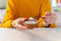 Woman hand holding spoon full of sugar health care concept.