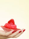Woman hand holding sweet strawberry cupcake Royalty Free Stock Photo