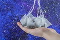 Woman hand holding tea bags on a colorful background Royalty Free Stock Photo