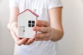 Woman hand holding toy model house  on white background. Real estate mortgage property insurance dream home Royalty Free Stock Photo