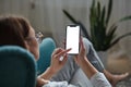 Woman hand holding using touch mobile phone white screen mockup Back view Royalty Free Stock Photo