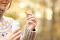 Woman hand holding a vitamin pill in autumn Royalty Free Stock Photo