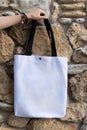 Woman hand holding white tote bag Royalty Free Stock Photo