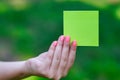 Woman hand holding a yellow notepaper Royalty Free Stock Photo