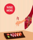 Woman hand holds by chopsticks maki sushi