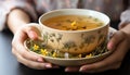 A woman hand holds a hot, refreshing bowl of organic tea generated by AI