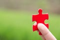 The woman hand holds a jigsaw, the background is sunset, solutions and strategy Concep