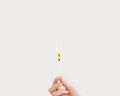 Woman hand holds lit match. Wooden matchstick is burning. Fire Hazard concept Royalty Free Stock Photo