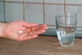 Woman hand holds a pill Royalty Free Stock Photo