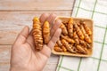 Woman hand holds raw whole curcuma rhizomes. Fresh turmeric roots on the palm closeup. Curcuma longa for cooking and ayurvedic