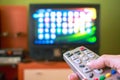 Woman hand holds remote control TV Royalty Free Stock Photo