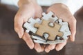 The woman hand holds a wooden jigsaw, solutions and strategy Concept Royalty Free Stock Photo