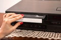 Nostalgic Moments: Inserting Blank VHS Cassette in Old Video Recorder