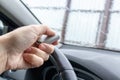 Woman hand inside the car, driver using remote control to open the automatic gate while leaving home, security system and save Royalty Free Stock Photo