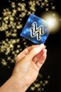 Woman hand keeping a blue card with zodiac symbol of Aquarius like astrology concept