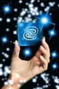 Woman hand keeping a blue card with zodiac symbol of Cancer like astrology concept