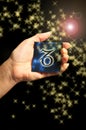 Woman hand keeping a blue card with zodiac symbol of Capricorn like astrology concept