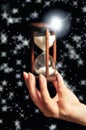 Woman hand keeping hourglass or sandglass like astrology and time  concept Royalty Free Stock Photo