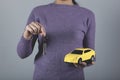 Woman hand key and car model Royalty Free Stock Photo