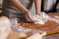 Woman Hand Kneaded Fresh Raw Dough on the Wooden Board Royalty Free Stock Photo