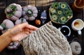 Woman hand knit handmade product with pumpkin background at morning coffee time