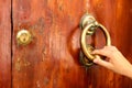 Woman hand knocking on the wooden door Royalty Free Stock Photo