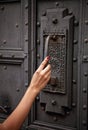 Woman hand knoking at the ancient door Royalty Free Stock Photo