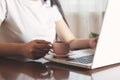 Woman hand komputer with coffee