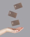 Woman hand and levitating plastic debit cards. Online shopping, booking, performing bank transactions concept Royalty Free Stock Photo