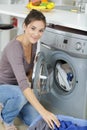 Woman hand loading dirty clothes in washing machine Royalty Free Stock Photo