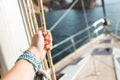 Woman hand on luxury yacht tackle.