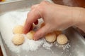 Woman hand making Beijinho de Coco, a traditional Brazilian candy called Coconuts Little Kiss