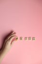 Woman hand making MeToo word with wooden alphabet on pink background, used for concept of sexual harrassment