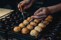 Woman hand making Takoyaki , Japanese street food