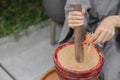 Woman hand making thai food call papaya salad or Som Tam, mixing and pounding in a mortar