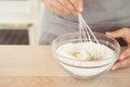 Woman Hand Mixed Batter on Clear Bowl with Baloon Whisk Step by Step Baking Preparation in the Kitchen Royalty Free Stock Photo