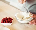 Woman Hand Mixed Batter on Clear Bowl with Baloon Whisk Step by Step Baking Preparation in the Kitchen Royalty Free Stock Photo