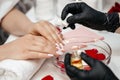 Woman hand nail care and manicure. Closeup of beautiful female hands applying transparent nail polish Royalty Free Stock Photo