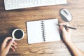 Woman hand notepad with coffee and keyboard